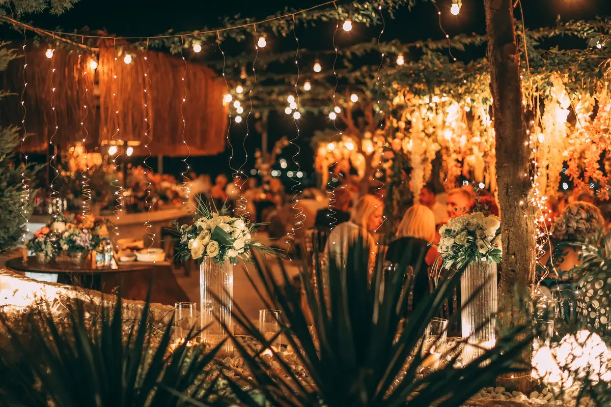A long table laid for a wedding dinner in an Italian courtyard